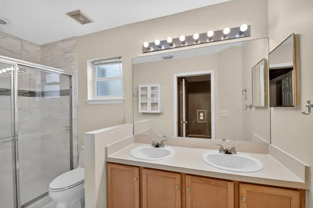 a bathroom with a sink toilet and shower
