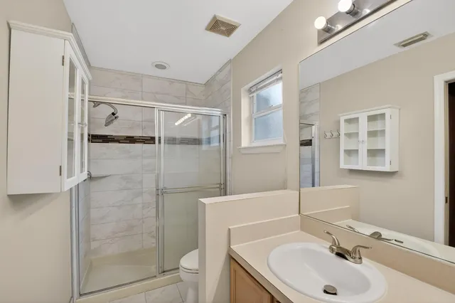 a spacious bathroom with a sink and a mirror