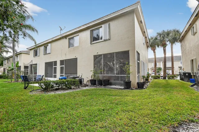 a view of an house with backyard space and balcony