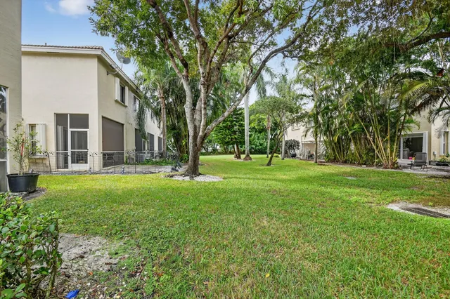 a view of backyard with large trees