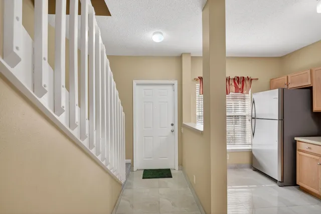 a view of a hallway with wooden floor and entryway