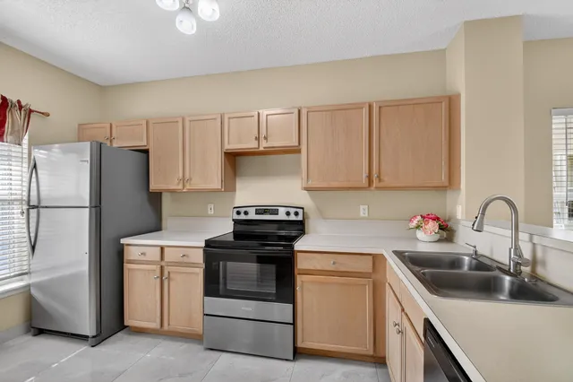 a kitchen with white cabinets and white appliances