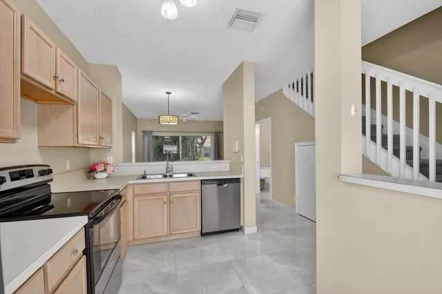 a kitchen that has a sink and a stove in it