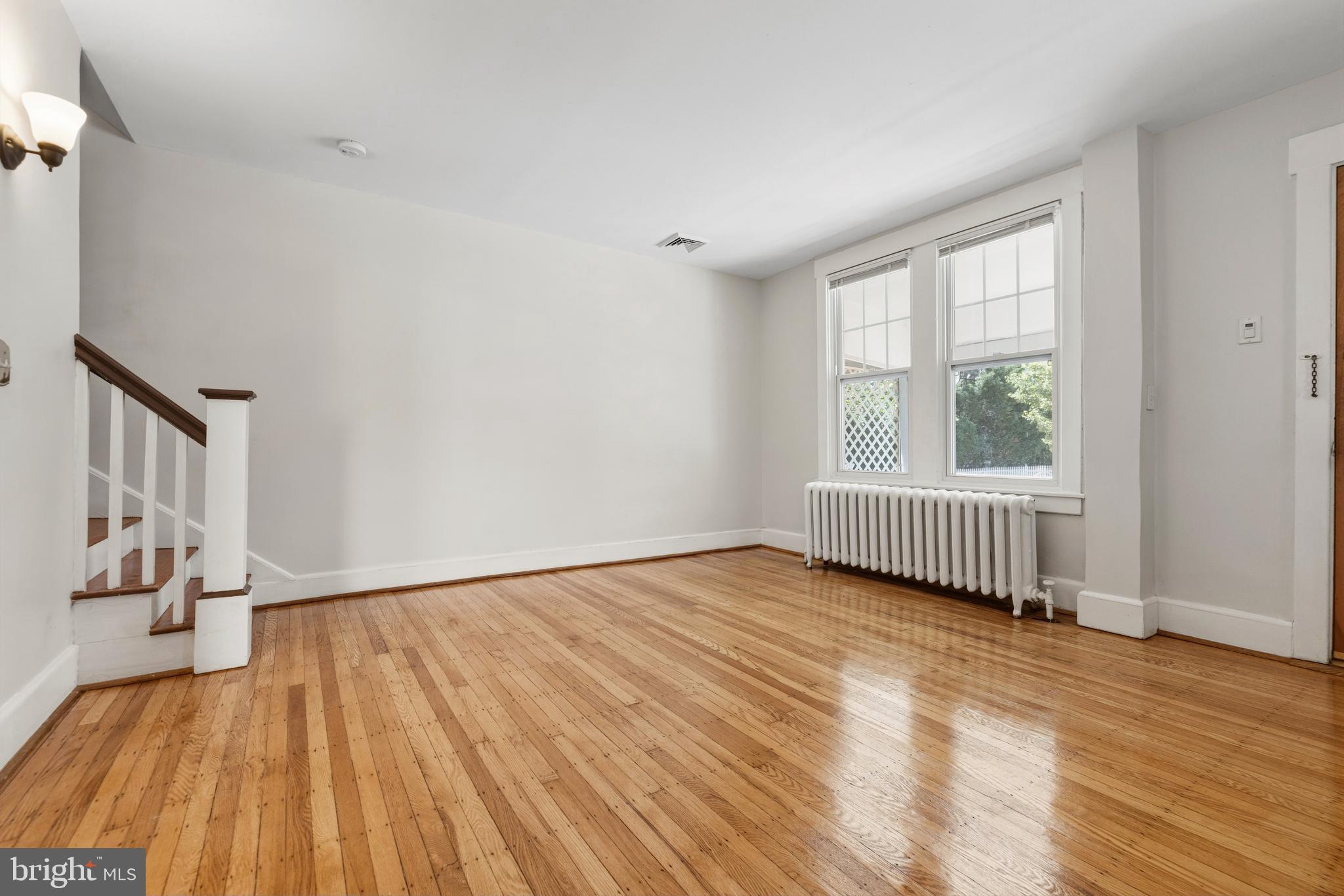 229 Wayne Avenue Narberth, PA 19072 - Photo 10 of 35 a view of an empty room with wooden floor and a window