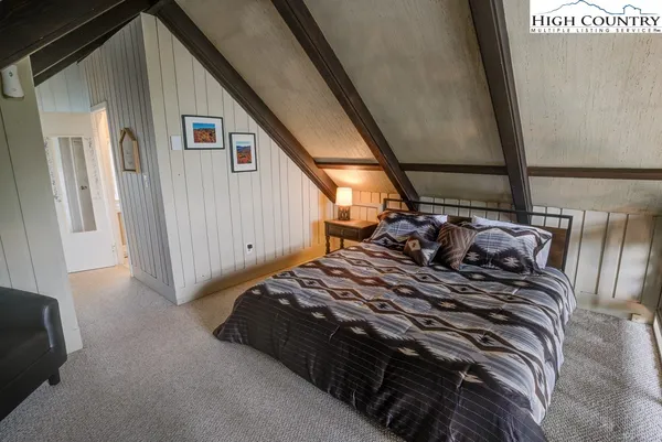 a bed sitting in a bedroom next to a window