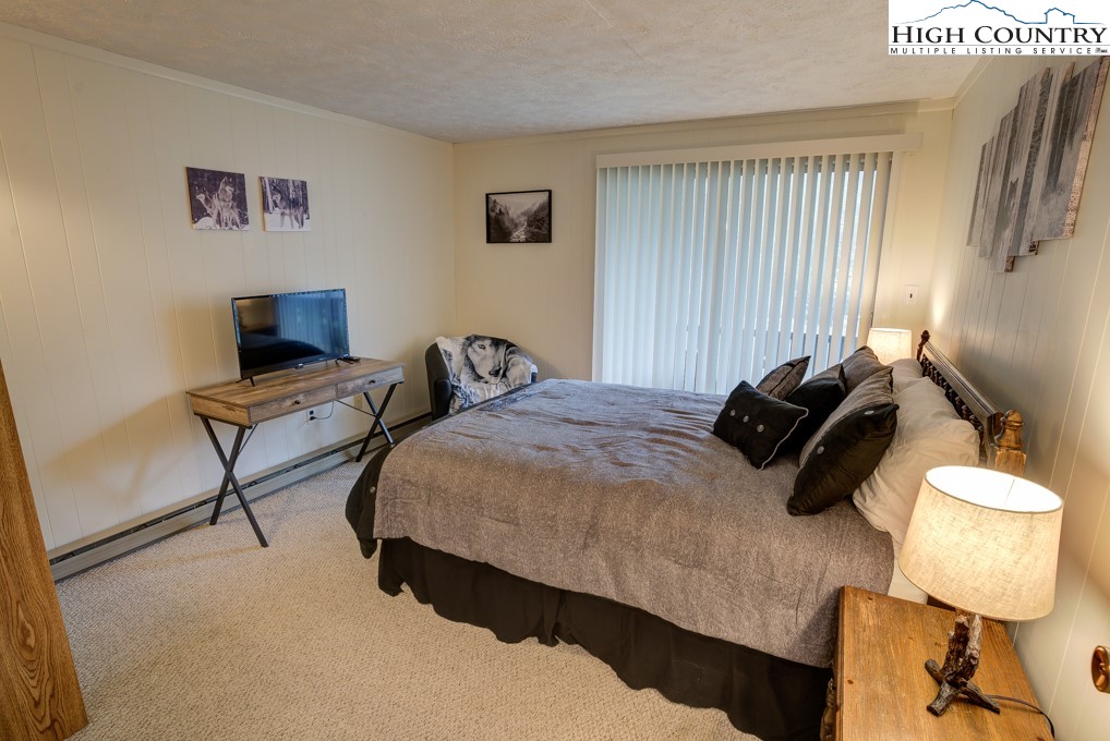105 North Pinnacle Ridge Road, Unit 5 Beech Mountain, NC 28604 - Photo 18 of 35 a bedroom with a bed and furniture