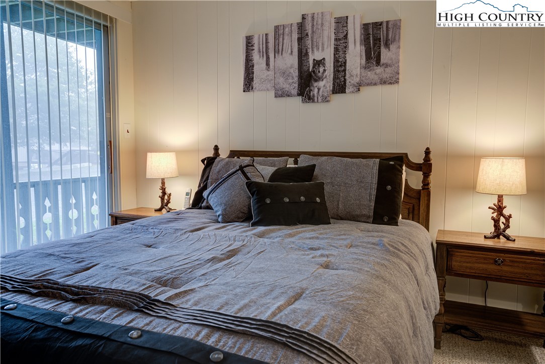 105 North Pinnacle Ridge Road, Unit 5 Beech Mountain, NC 28604 - Photo 20 of 35 a bedroom with a bed and wooden floor