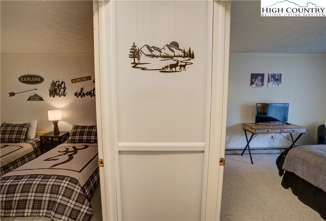 105 North Pinnacle Ridge Road, Unit 5 Beech Mountain, NC 28604 - Photo 21 of 35 a bedroom with a bed and a couch