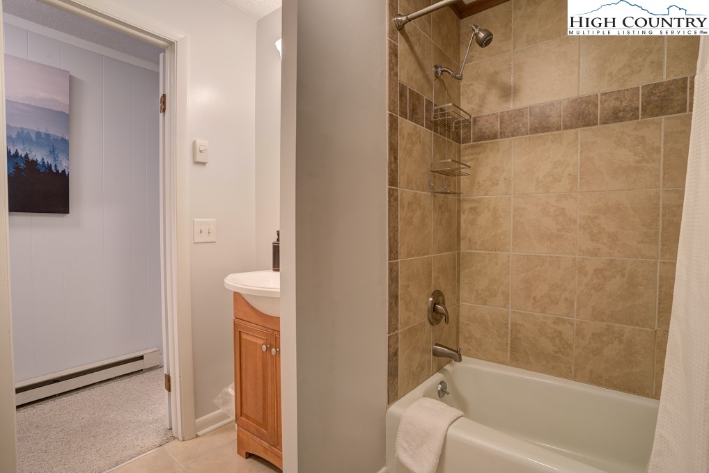 105 North Pinnacle Ridge Road, Unit 5 Beech Mountain, NC 28604 - Photo 22 of 35 a bathroom with a tub and a shower