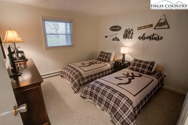 a bedroom with bed and a window