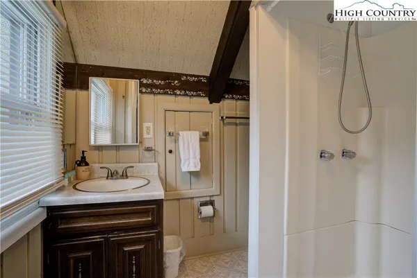 a bathroom with a sink vanity and a mirror