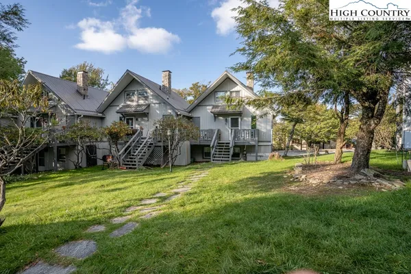 a yellow house sitting in middle of the middle of a park