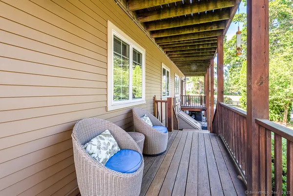 a view of balcony with couch and chairs