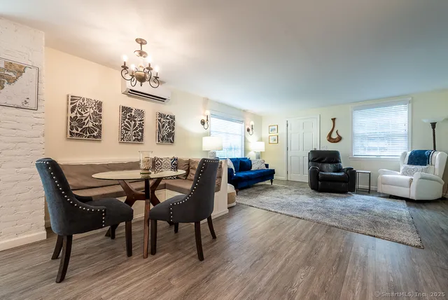 a living room with furniture and a chandelier