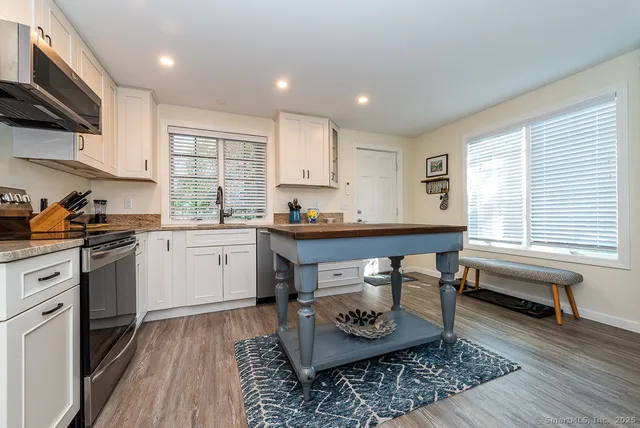 a kitchen with a sink stove and cabinets