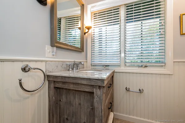 a kitchen with stainless steel appliances granite countertop wooden cabinets granite counter tops and a window