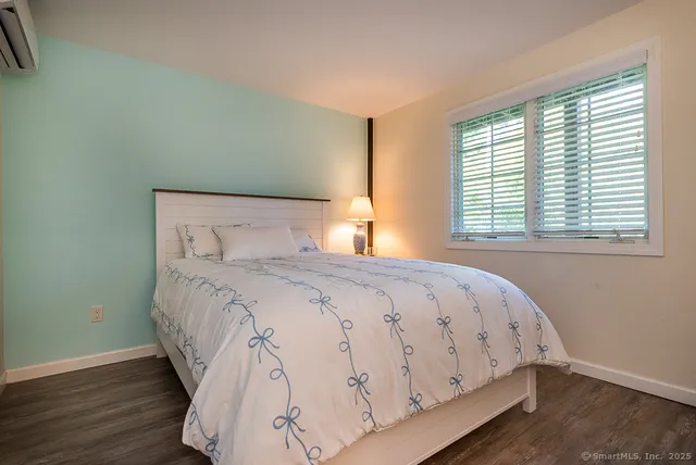 a bathroom with a granite countertop sink and a window