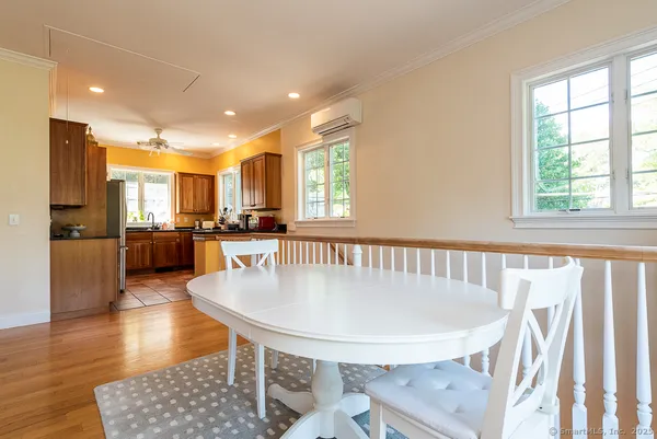 a dining room with furniture and wooden floor