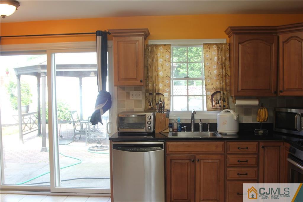 55 Knollwood Road Edison, NJ 08817 - Photo 11 of 25 a kitchen with stainless steel appliances granite countertop a refrigerator and a sink