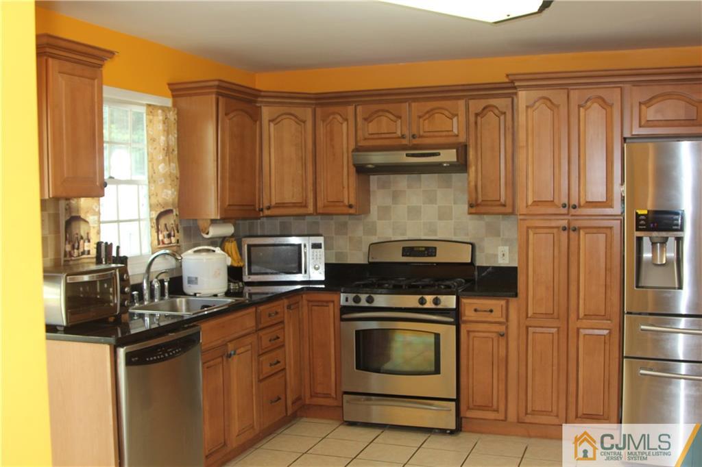 55 Knollwood Road Edison, NJ 08817 - Photo 13 of 25 a kitchen with a refrigerator stove and sink