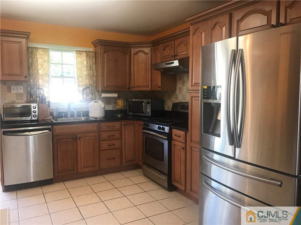 55 Knollwood Road Edison, NJ 08817 - Photo 15 of 25 a kitchen with stainless steel appliances granite countertop a refrigerator and a sink
