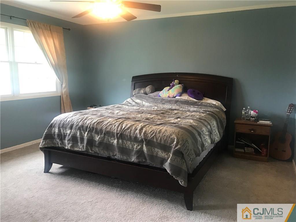 55 Knollwood Road Edison, NJ 08817 - Photo 20 of 25 a bed sitting in a bedroom next to a window