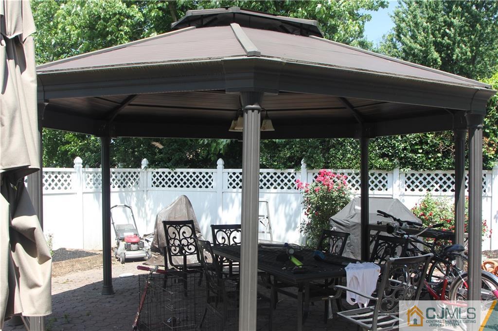55 Knollwood Road Edison, NJ 08817 - Photo 25 of 25 a view of a patio with table and chairs under an umbrella