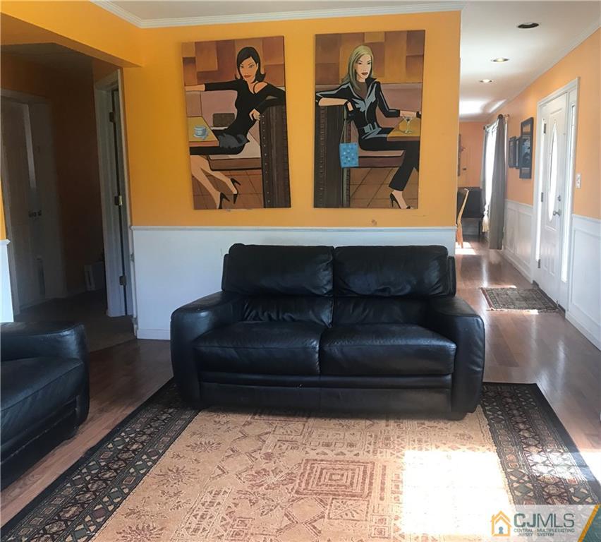 55 Knollwood Road Edison, NJ 08817 - Photo 8 of 25 a living room with couches and a fireplace with wooden floor