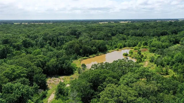 an aerial view of a houses with a yard