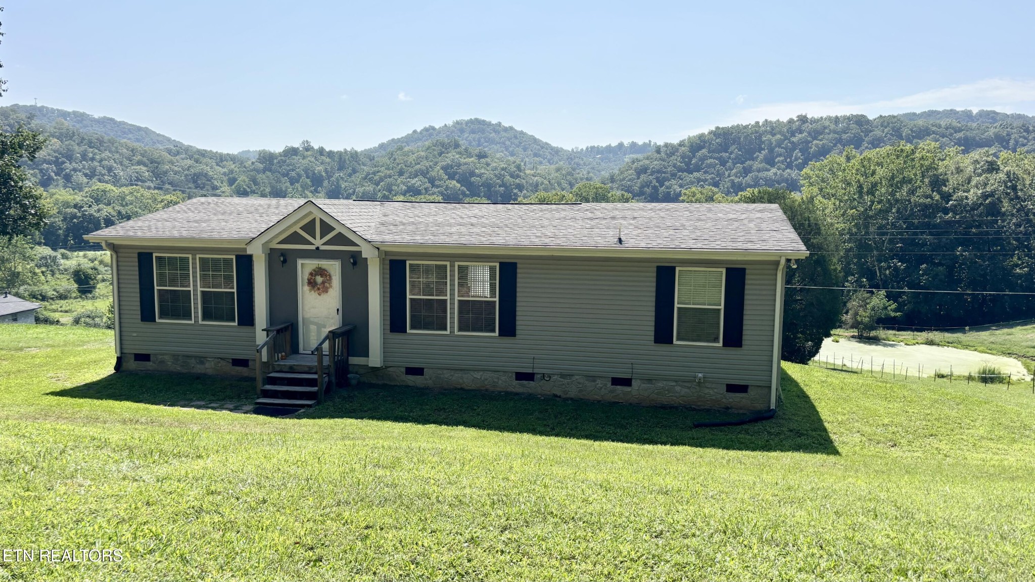 9400 Pedigo Road Powell, TN 37849 - Photo 1 of 18 a view of a house with a garden and yard