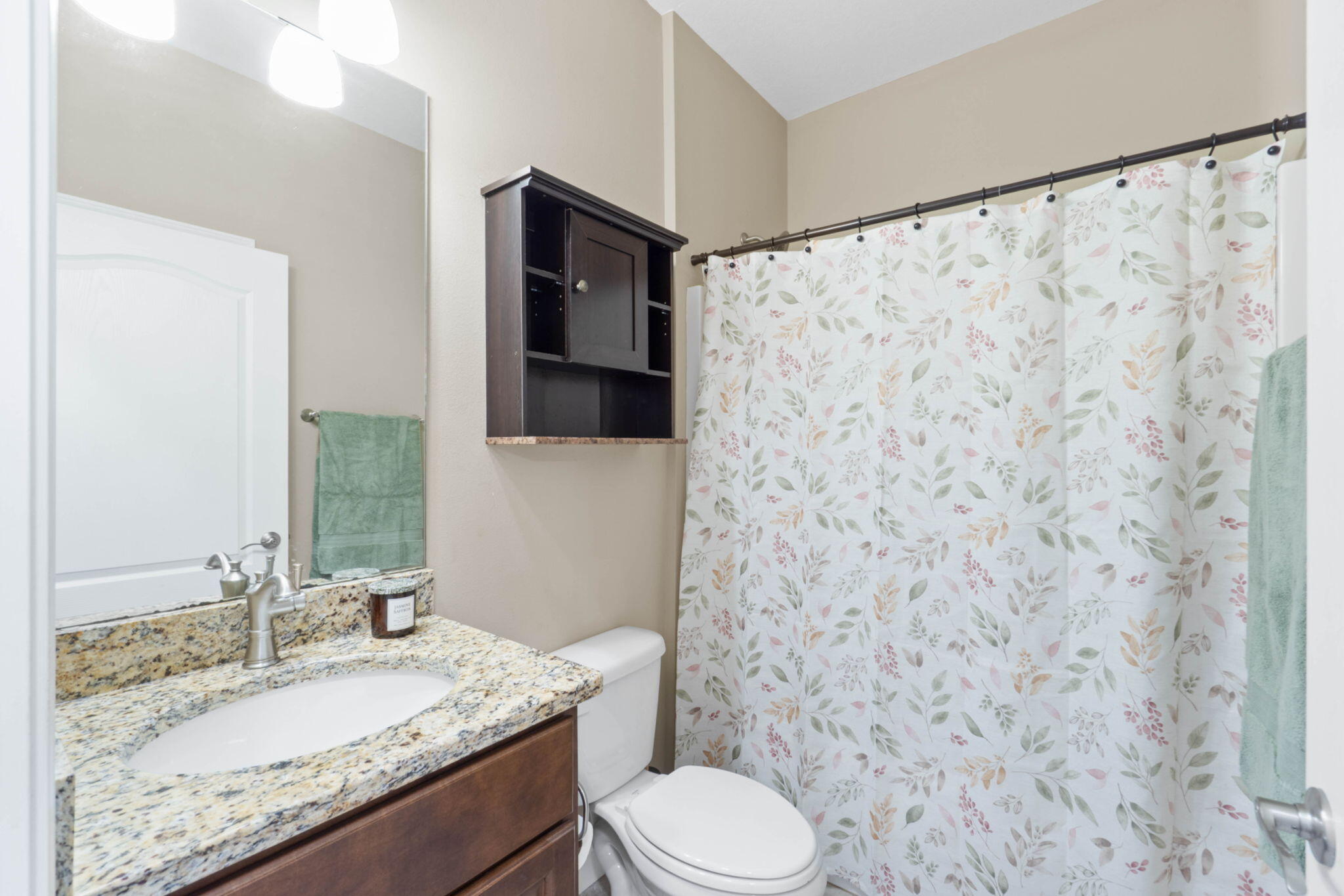 438 Brackin Street Crestview, FL 32539 - Photo 11 of 26 a bathroom with a granite countertop sink toilet and a mirror