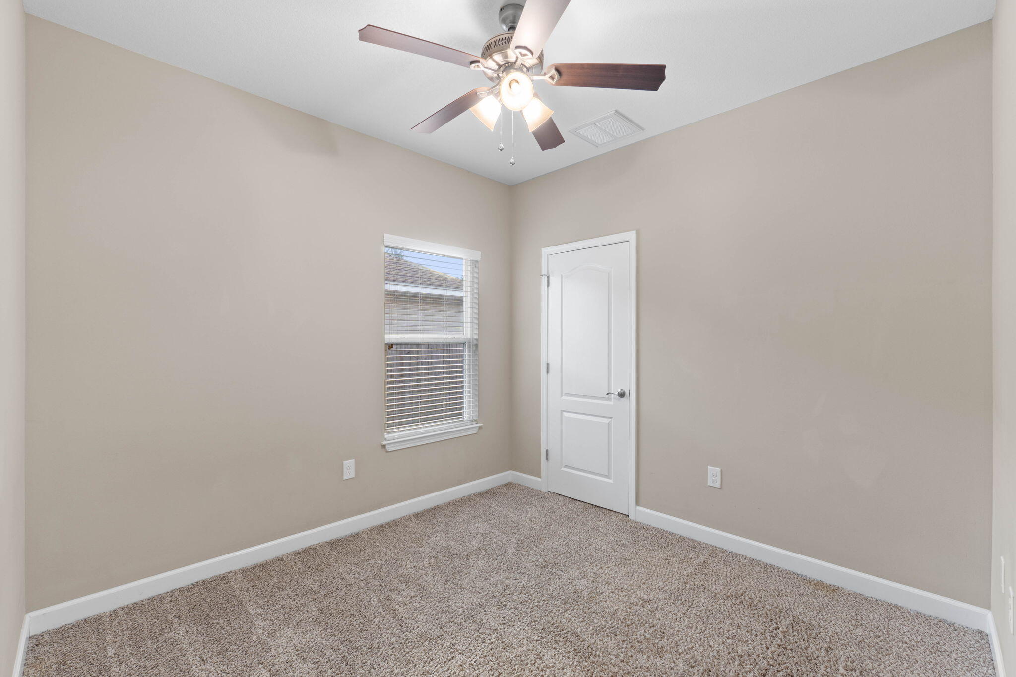 438 Brackin Street Crestview, FL 32539 - Photo 12 of 26 an empty room with windows and fan