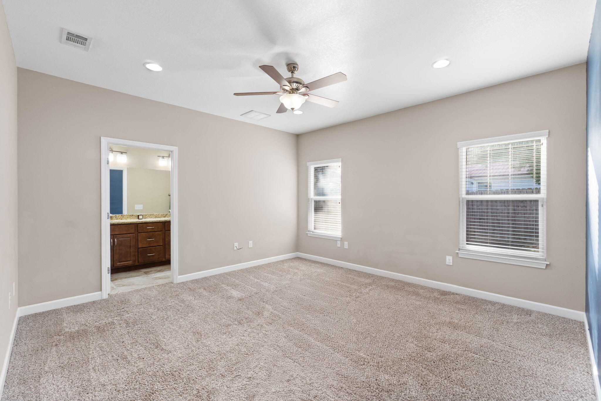 438 Brackin Street Crestview, FL 32539 - Photo 14 of 26 an empty room with windows and a ceiling fan