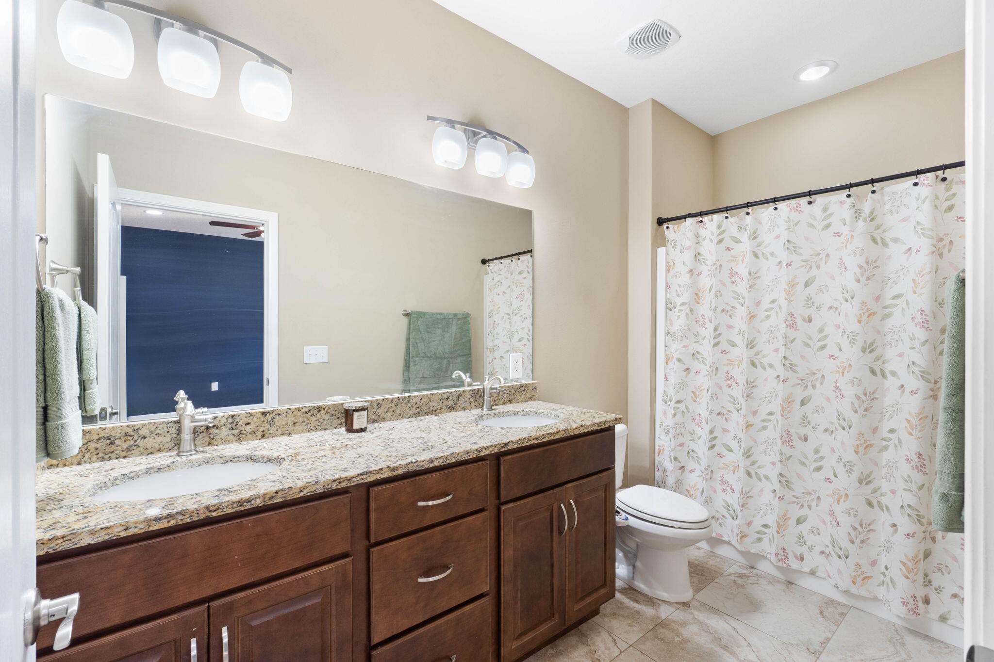 438 Brackin Street Crestview, FL 32539 - Photo 16 of 26 a bathroom with a granite countertop sink toilet and shower