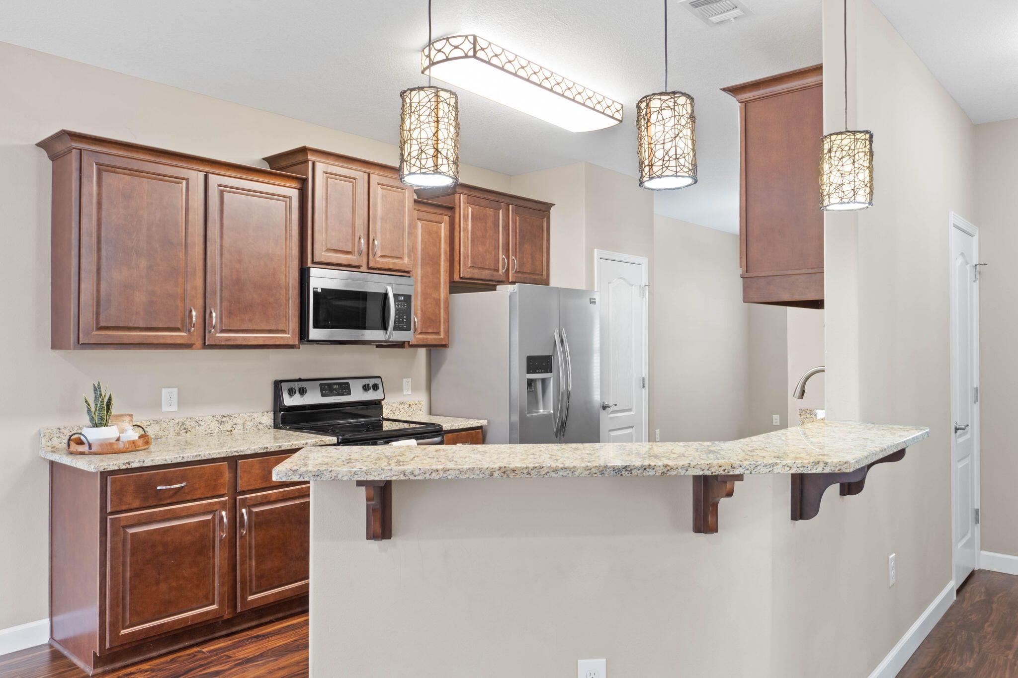 438 Brackin Street Crestview, FL 32539 - Photo 7 of 26 a kitchen with stainless steel appliances granite countertop a stove a sink dishwasher a refrigerator and a microwave oven