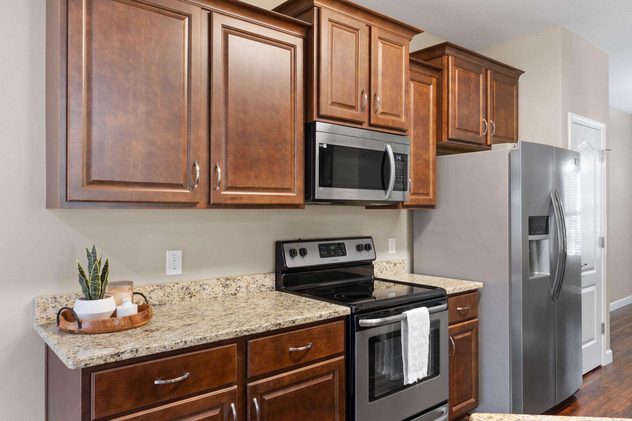 438 Brackin Street Crestview, FL 32539 - Photo 8 of 26 a kitchen with stainless steel appliances granite countertop a refrigerator stove and microwave