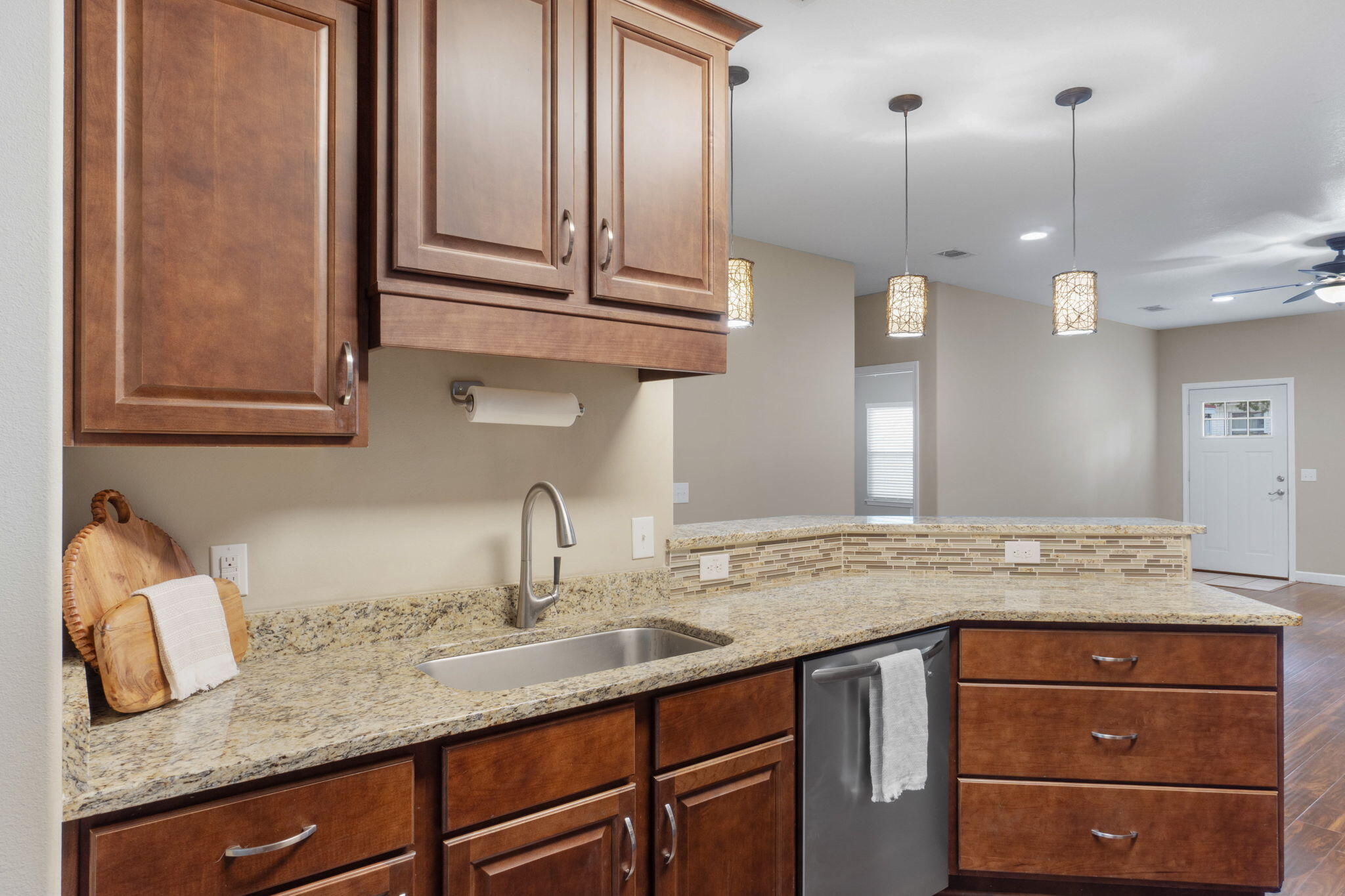 438 Brackin Street Crestview, FL 32539 - Photo 9 of 26 a kitchen with granite countertop stainless steel appliances sink and wooden floor