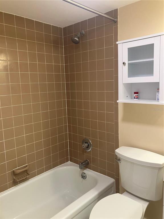 3006 Caring Way, Unit 612 Port Charlotte, FL 33952 - Photo 17 of 20 a bathroom with a toilet a sink and mirror