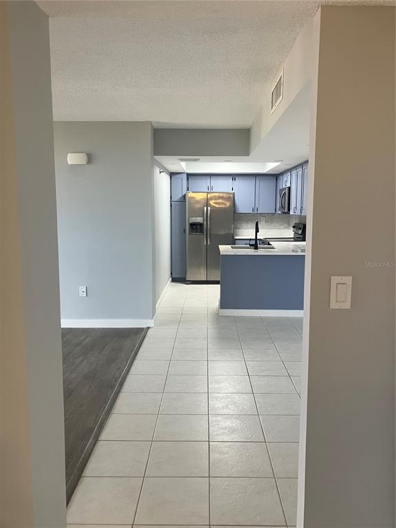 3006 Caring Way, Unit 612 Port Charlotte, FL 33952 - Photo 5 of 20 a kitchen with stainless steel appliances a sink and cabinets