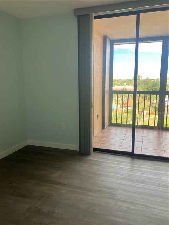 3006 Caring Way, Unit 612 Port Charlotte, FL 33952 - Photo 8 of 20 a view of an empty room with wooden floor and a window