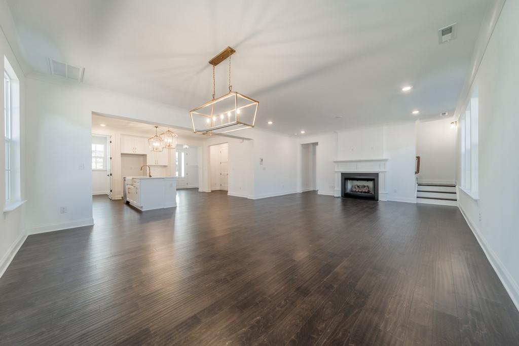 3210 Timber Run Lane Maiden, NC 28650 - Photo 14 of 30 a view of a livingroom with wooden floor a fireplace and a window