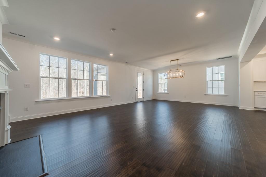 3210 Timber Run Lane Maiden, NC 28650 - Photo 16 of 30 an empty room with wooden floors and windows