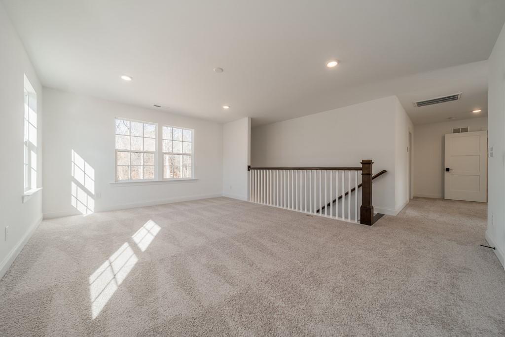 3210 Timber Run Lane Maiden, NC 28650 - Photo 21 of 30 a view of an empty room with a window and stairs