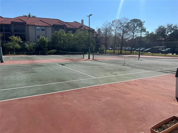 a living room with furniture a fireplace and large windows