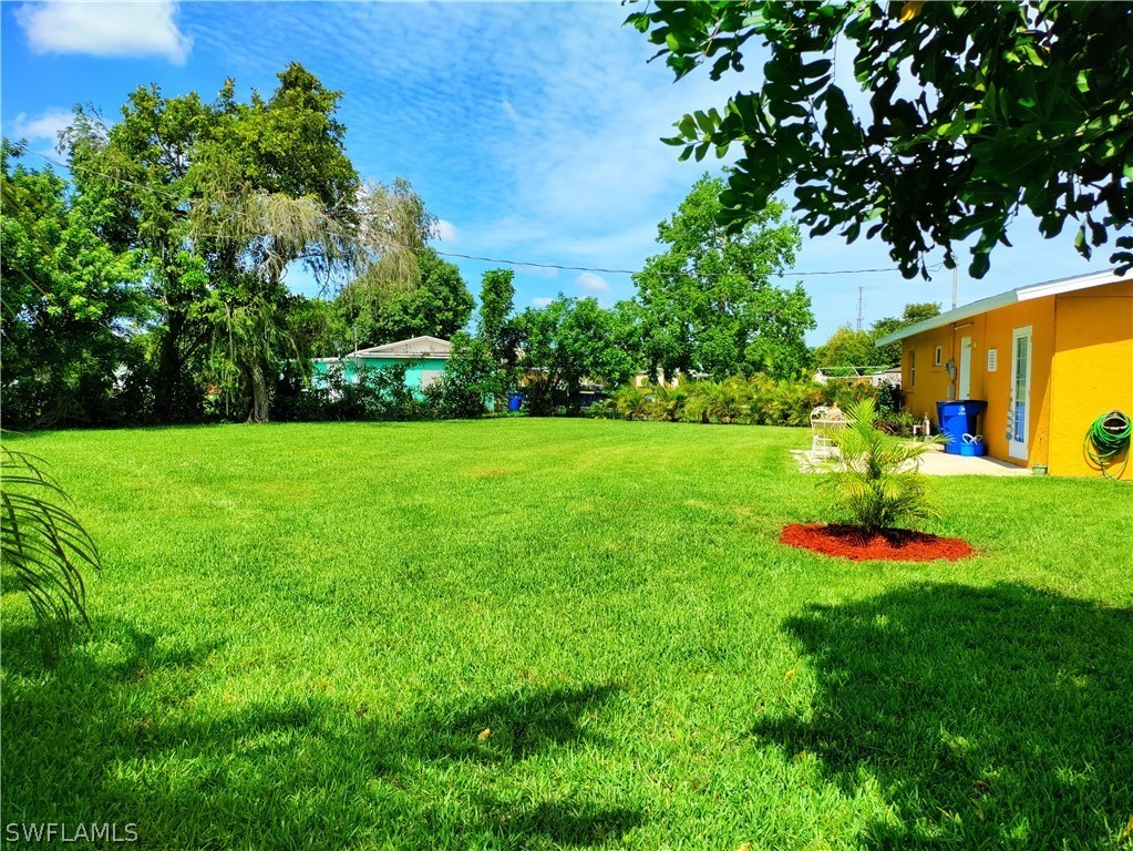 202 Davis Road Lehigh Acres, FL 33936 - Photo 13 of 16 a view of a backyard with swimming pool