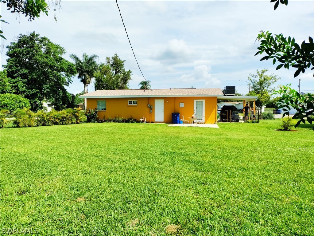 202 Davis Road Lehigh Acres, FL 33936 - Photo 15 of 16 a view of a house with a yard