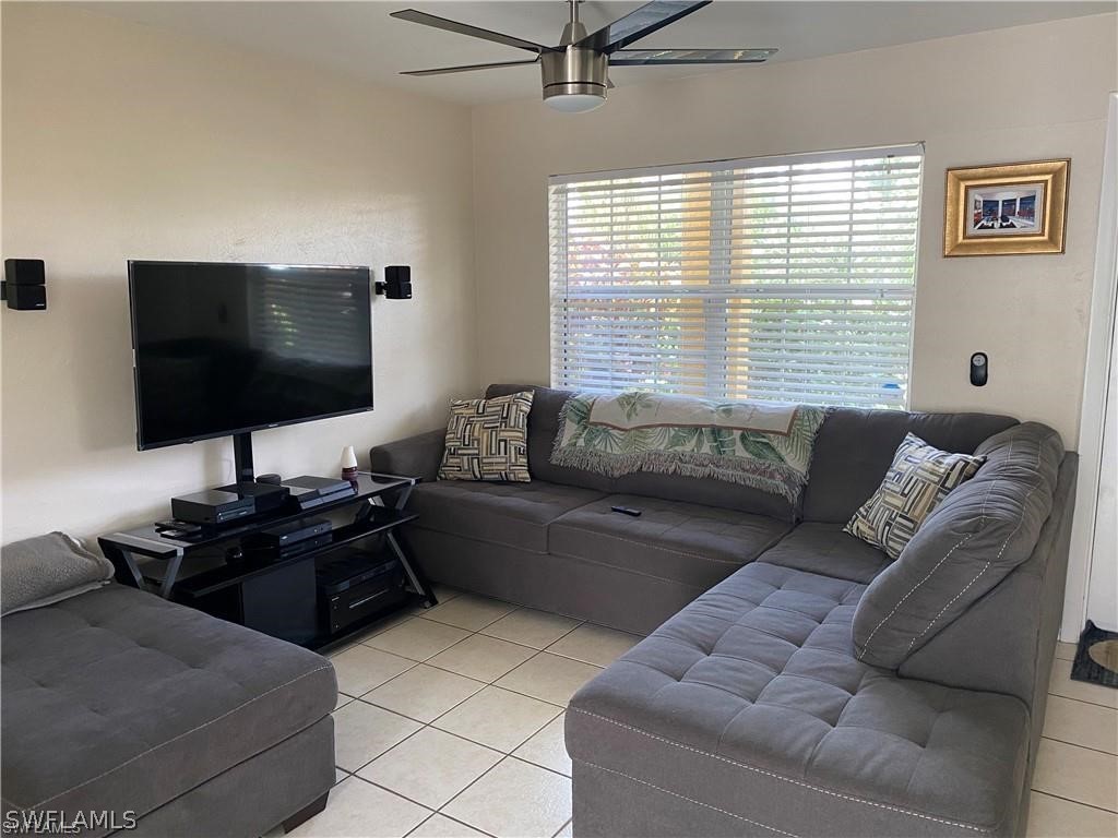 202 Davis Road Lehigh Acres, FL 33936 - Photo 3 of 16 a living room with furniture and a flat screen tv