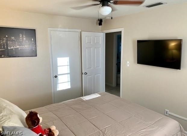 202 Davis Road Lehigh Acres, FL 33936 - Photo 8 of 16 a bedroom with a bed and a flat screen tv