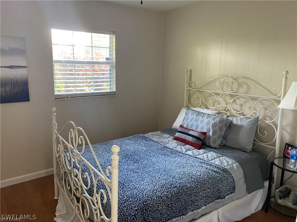 202 Davis Road Lehigh Acres, FL 33936 - Photo 10 of 16 a bed sitting in a bedroom next to a window