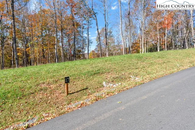 a view of backyard with wooden fence